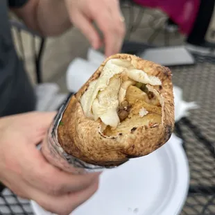 a person holding a sandwich