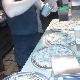 Pizza Chef preparing pizzas.