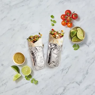 two burritos on a marble table