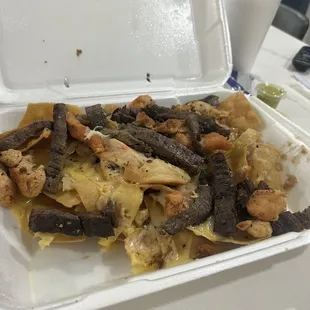 Dry and hard pieces of chicken and beef fajitas with cold and hard cheese