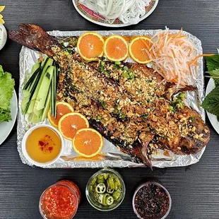 CÁ NƯỚNG DA DÒN
Our signature crispy baked catfish.  Baked to order and served with rice vermicelli, rice paper, veggies and various sauces