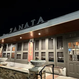 the entrance of a restaurant at night