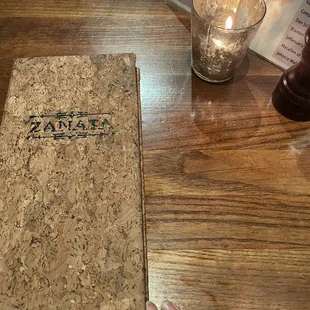 a person holding a book on a table