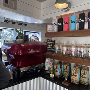 a red coffee machine in a coffee shop