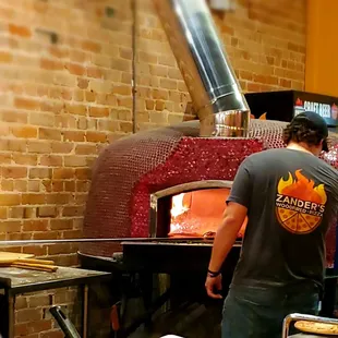 two men working in a brick oven