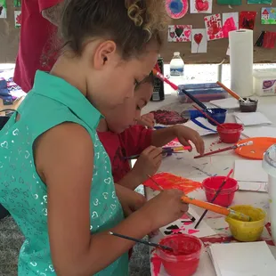 Two aspiring artists hard at work at the ZMA booth during the Y-Bridge Arts Festival.
