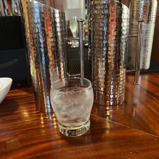 a glass of water on a bar