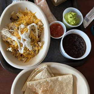 tortillas, guacamole, and salsa on a tray