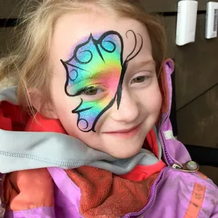Rainbow butterfly by Zanypaint Face Painting.