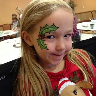 Christmas party holly leaves face painting by Zanypaint Face Painting.