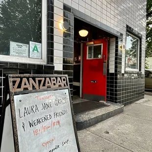 a sign in front of a restaurant