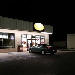 a car parked in front of a restaurant