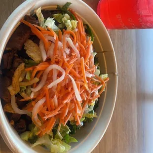 Steak bowl with sweet teriyaki sauce, broccoli, brown rice, carrots, and crispy onions.