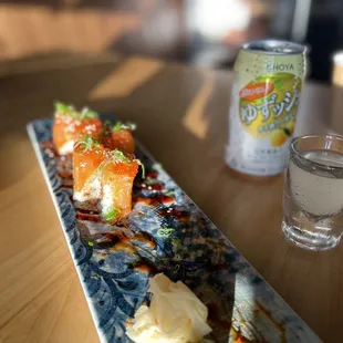 a plate of sushi and a can of soda