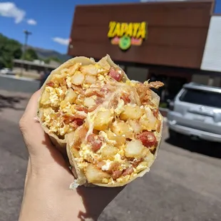 a person holding a burrito