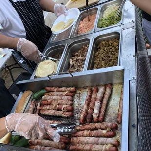 a man serving hot dogs
