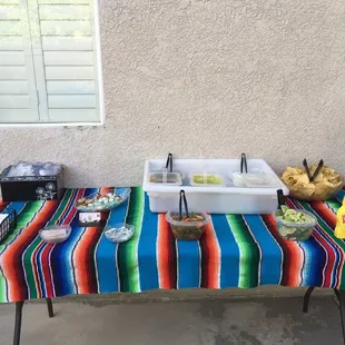 The set-up for the salsas, condiments, utensils.
