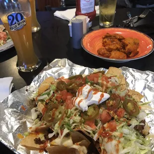Loaded nachos with ground beef and boneless buffalo wings