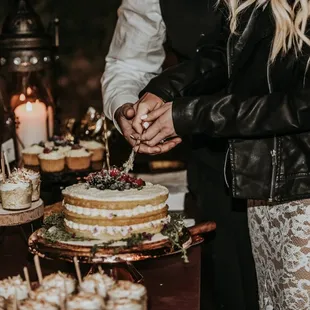 a bride and groom cutting their wedding cake