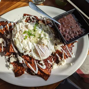 Mole chiliquiles and black beans eggs over medium.
