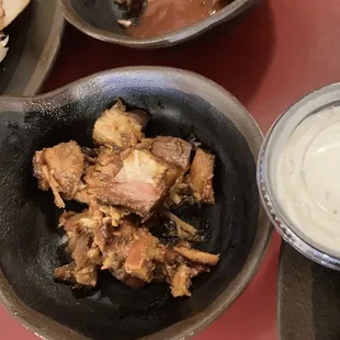 A scoop of beef burnt ends and a scoop of pork burnt ends