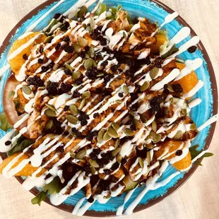Punjabi Desi-Paleo Salad:  Grilled Chicken Boti, mixed greens, oranges, currents, pumpkin seeds with chutney dressing.