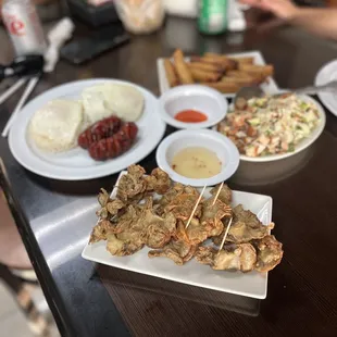 Crispy pork ruffled fat , Lumpia  Pork belly sisig ,Garlic fried rice with longanisa.