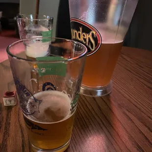two glasses of beer on a table