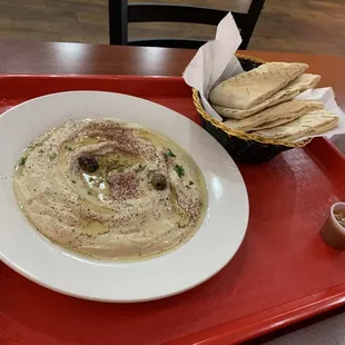 a bowl of hummus and pita chips