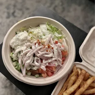 Beef and lamb rice bowl with veggies, garlic paste and Tzatziki Sauce
