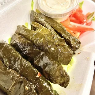 a tray of stuffed grape leaves