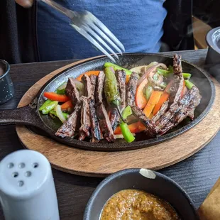 Beef fajitas.  Came with small pot of rice and tiny pot of beans or something like that.