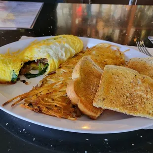 Vegetable omelet with spinach, onions, tomatoes, mushrooms, and cheese. With hash browns and rye toast $13.50
