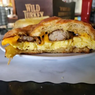 Breakfast sandwich with sausage on a croissant $7. Goes perfectly with an Irish coffee.