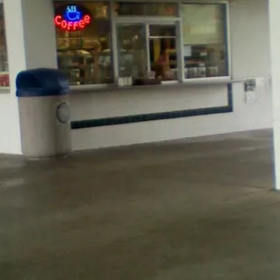 a zebra standing in front of a store