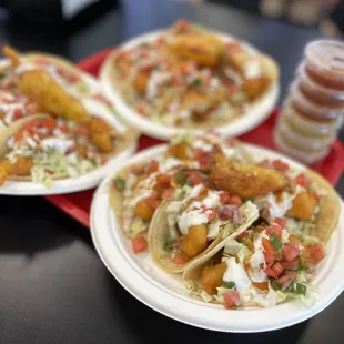 three plates of fish tacos
