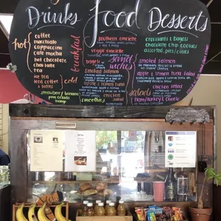 Front counter with a display of pastries &amp; menu.