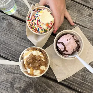 Banana with peanut butter drizzle and Reese&apos;s, strawberry with chocolate drizzle, and pineapple with rainbow sprinkles