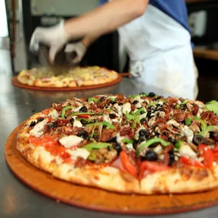 two pizzas on a table