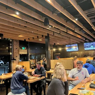 people sitting at tables in a restaurant