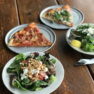 three plates of food on a wooden table