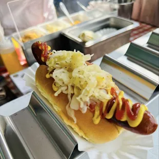 Hot dog with sauerkraut, onions, ketchup and mustard
