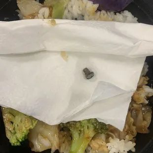 a plate of food with rice, broccoli and onions