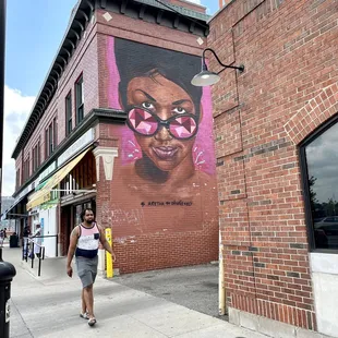 a woman walking down the sidewalk