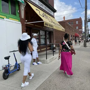 a woman walking down the sidewalk