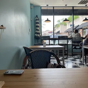 a woman sitting at a table in a restaurant