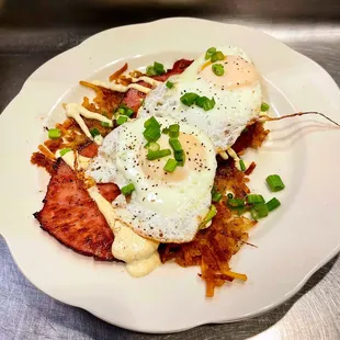 Ham steak over crispy shoestring potatoes, over easy eggs , mustard cream sauce