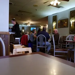 people sitting at tables in a restaurant