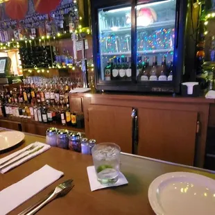 a bar with a man sitting at the bar