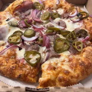 Order from Zella's that was hand tossed crust with spicy red pepper sauce and ham, steak, jalapeños, and red onions as toppings!